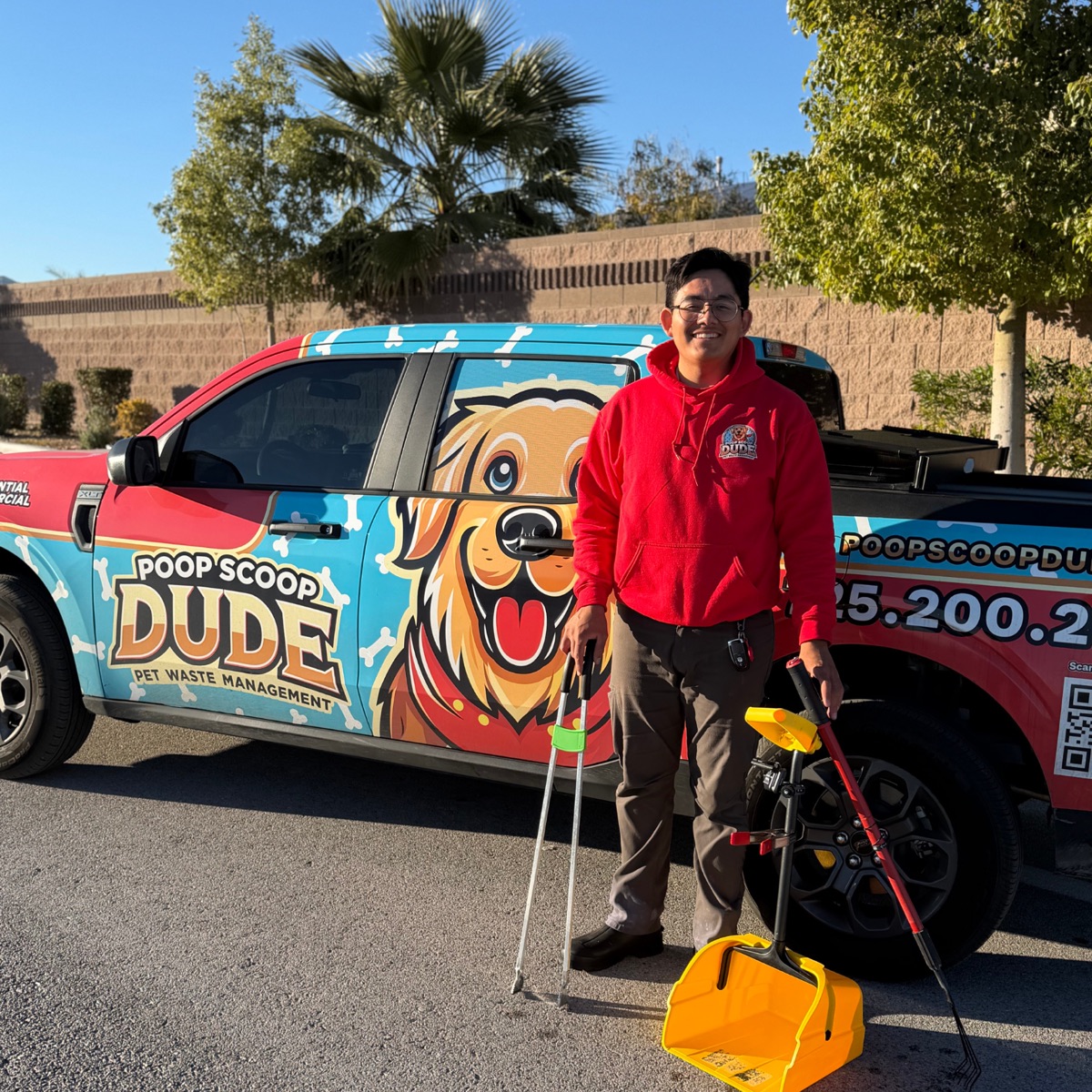 Gianny, the Poop Scoop Dude owner, by his wrapped red truck in Las Vegas