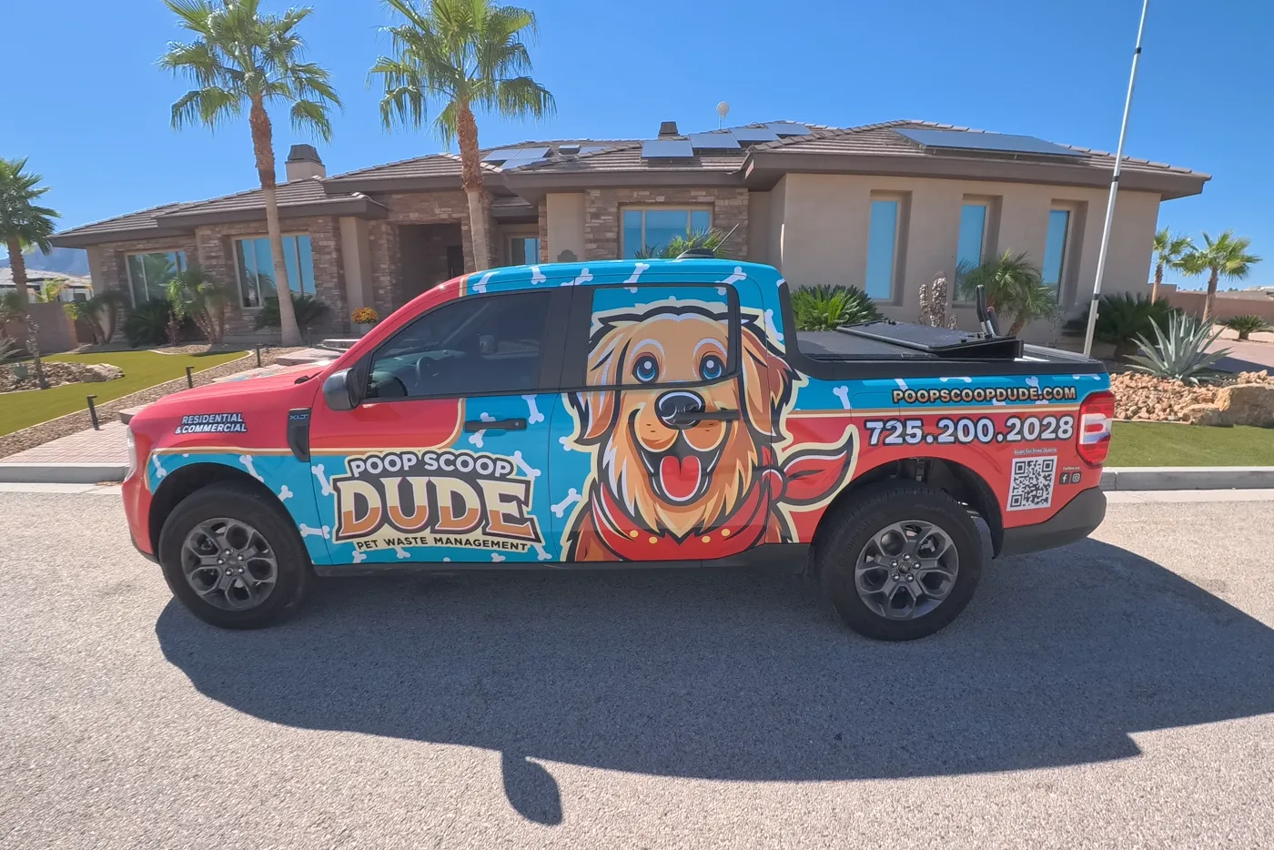 The Poop Scoop Dude truck parked at the curb of a Las Vegas home